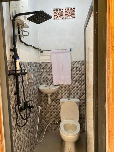 a small bathroom with a toilet and a sink at Sabin view homestay in Licin