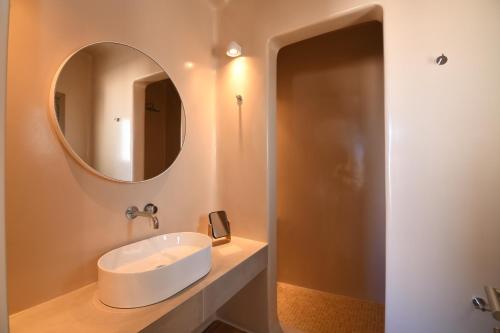 a bathroom with a sink and a mirror at Santorini - Villa - Sleeps 4 - Pool - Parking in Mesaria