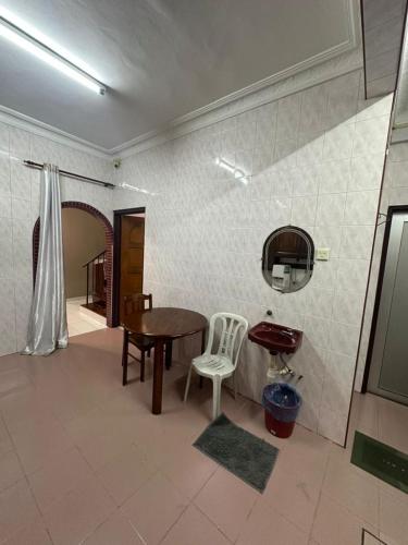 a dining room with a table and a chair at Kapar Cozy Homestay in Kapar
