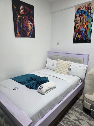 a bed in a room with a painting on the wall at ML STUDIO with Rooftop, Free wifi, Free Parking in Nakuru
