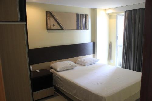 Ένα ή περισσότερα κρεβάτια σε δωμάτιο στο Apart-Hotel Terraços do Atlântico