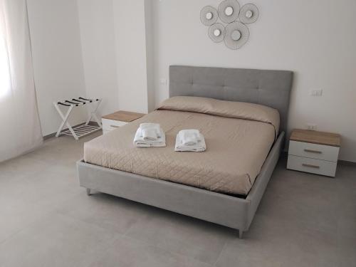 a bedroom with a bed with two towels on it at Venice Delta Lagoon Apartments in Porto Viro