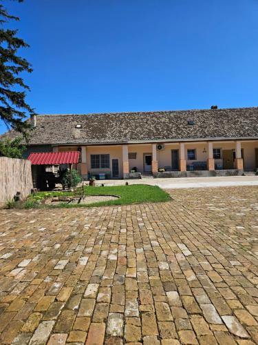 a building with a brick driveway in front of it at Apartmany Detvanka in Bački Petrovac