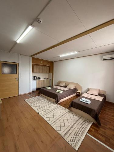 a room with two beds and a television in it at Микрон in Zatoka