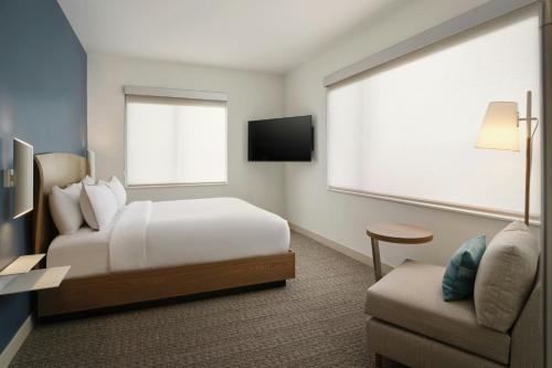 a hotel room with a bed and a couch at Element by Marriott Pooler Savannah Airport in Savannah