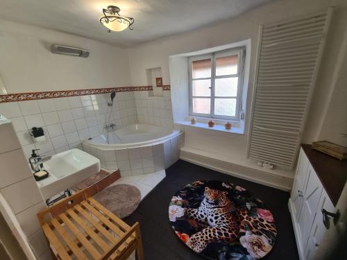 a bathroom with a bath tub and a leopard rug at Ferienhaus Mia in Neumagen-Dhron