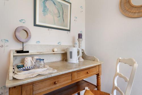 a room with a wooden table with a mirror at Chambres D'hôtes Kergollay in Lanhouarneau