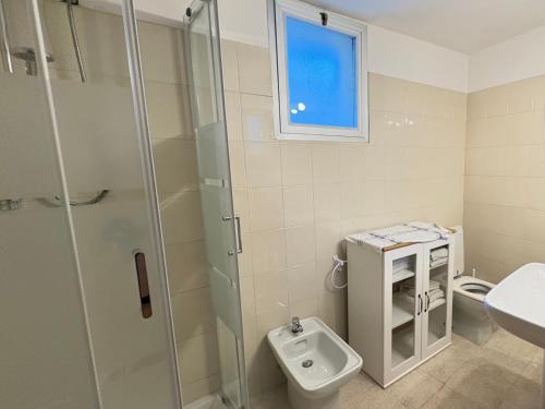 a bathroom with a shower and a toilet and a sink at 4VENTI by LigurianLife in Vallebona