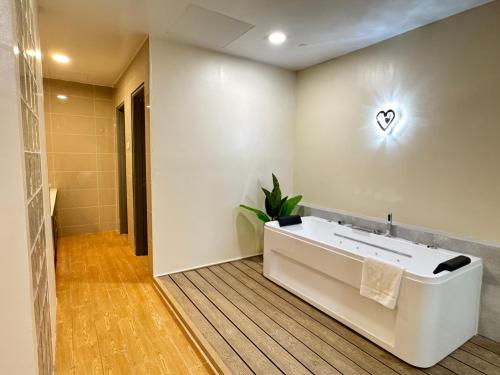 a bathroom with a white tub and a sink at D Gateway Perdana Hotel Bangi in Bangi