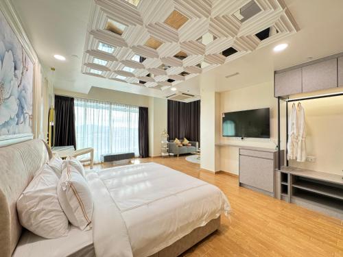 a large bedroom with a large bed and a flat screen tv at D Gateway Perdana Hotel Bangi in Bangi