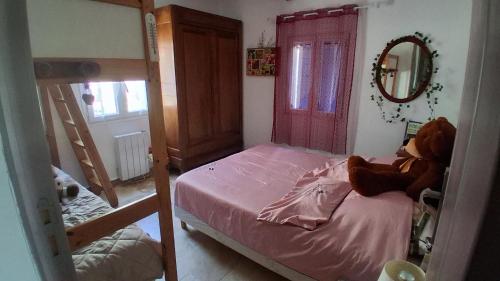 a bedroom with a bunk bed with a teddy bear on it at Chez Mich'An Luberon in Saignon