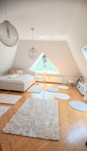 a living room with a bed and a window at Villa Panorama in Biatorbágy