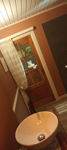 a bathroom with a white sink and a window at Désir D'un Soir in Lessines