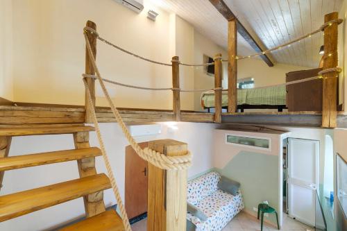 a room with two bunk beds and a swing at Villa Piuma in Finale Ligure