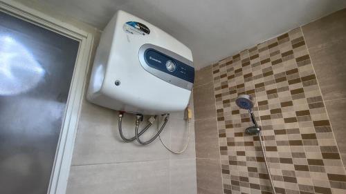 a shower with aitizer at Student Castle Apartement by Dev's Room in Seturan