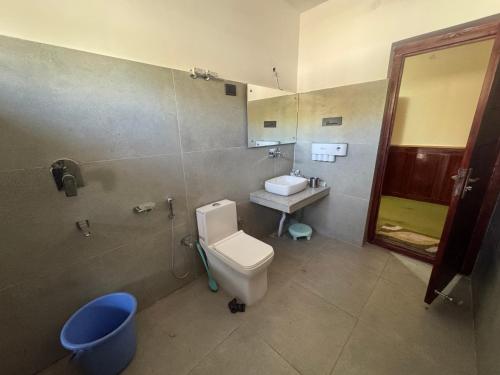 a bathroom with a toilet and a sink at Cho Farm House in Leh