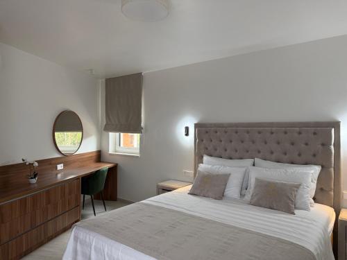 a bedroom with a large bed and a desk at Navis Suites & Spa in Mandre