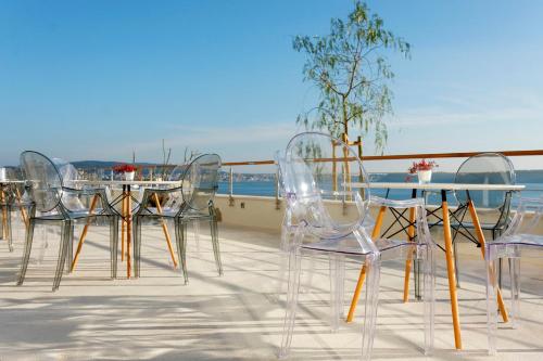 a group of clear chairs and tables on a roof at Hotel Ola - Adults Only in Trogir