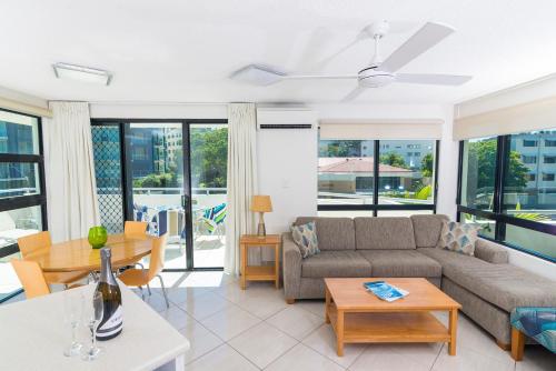 a living room filled with furniture and a window at Beach Club Resort Mooloolaba in Mooloolaba