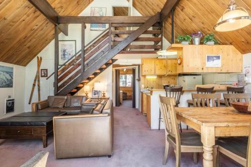 a kitchen and dining room with a wooden ceiling at Chalet 15 by Mammoth Mountain Chalets in Mammoth Lakes