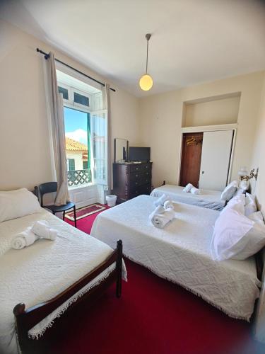 a hotel room with two beds and a window at Mirasol Guesthouse in Funchal