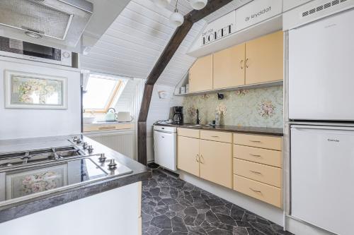 a kitchen with a white refrigerator and a stove at Lyckebo in Gunnebo