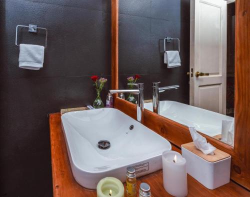 a bathroom with a white sink and a mirror at Hazaar Dastaan Kashmir in Srinagar
