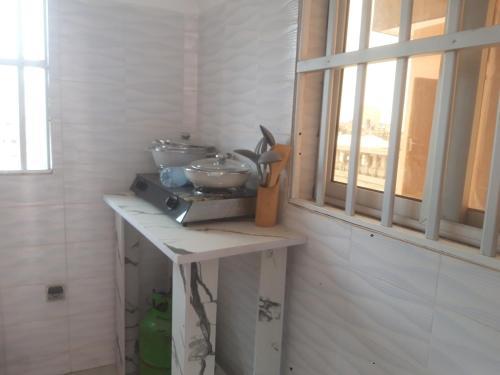 a kitchen counter with two bowls on it next to a window at DAVADI loc in Cotonou