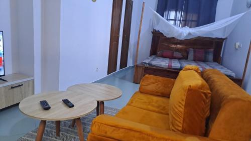 a living room with a couch and a bed at DAVADI loc in Cotonou