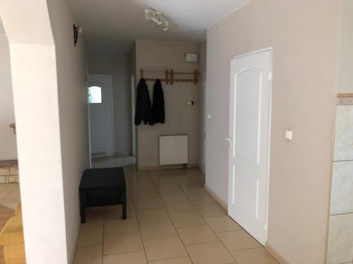 a hallway with a door and a chair in a room at Apartament Zielone Buki in Buczkowice