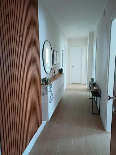 a hallway with a mirror and a vanity and a mirror at Casa Tania in Massa