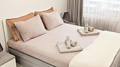 a bedroom with a bed with towels on it at Lux 2 Central Apartment with Garage in Plovdiv