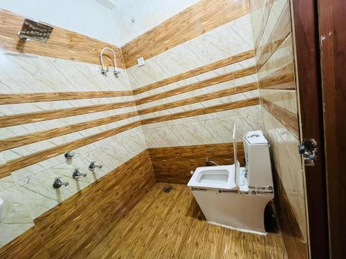 a bathroom with a toilet and a shower at HOTEL SIYARAM Inn in Jāmb