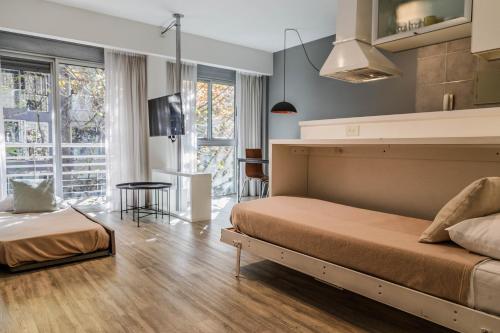 a bedroom with a bed and a tv in a room at Color Botánico in Buenos Aires