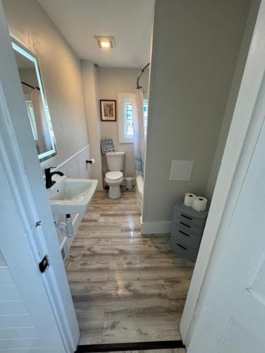 a bathroom with a sink and a toilet and a tub at Sun2Sand Beach House in Salisbury