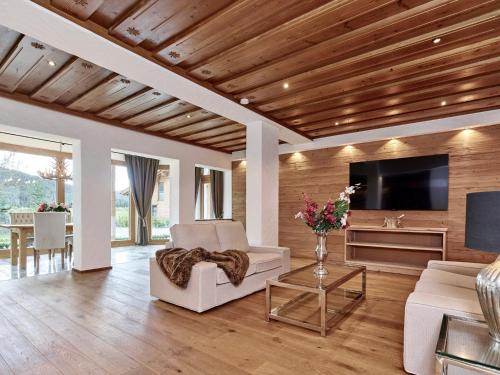 a living room with a couch and a tv at Jagd Chalet in Leutasch