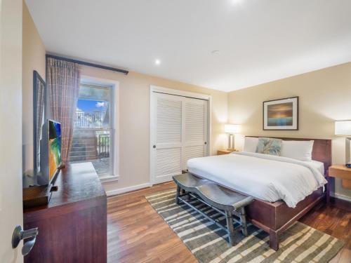 a bedroom with a large bed and a window at 3-Bed Villa 115 at Turtle Bay in Kahuku
