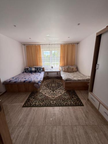 a living room with two beds and a window at 9 Dańce - comfortable accommodation 22-220 - WIFI included in Dańce