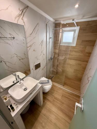 a bathroom with a toilet and a sink and a shower at ΑVLI Sarti Superior Studio no5 in Sarti