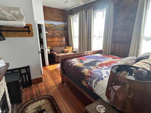 a bedroom with a bed and a couch in a room at Aspen Inn in Creede