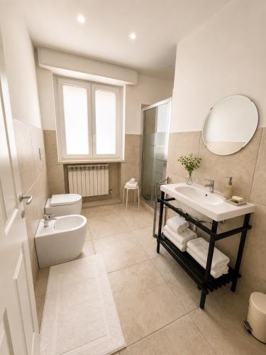 a bathroom with a sink and a toilet and a mirror at Canneddi Boutique Farm in Avetrana