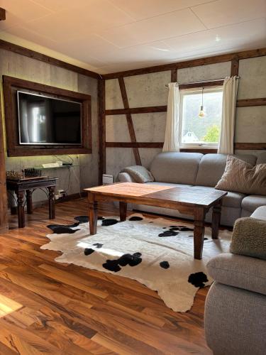 a living room with a couch and a coffee table at The Chess House Lofoten - Luxury Arctic Villa in Fredvang in Fredvang