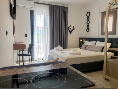 a hotel room with two beds and a table at Olea Luxury Suites in Asprovalta