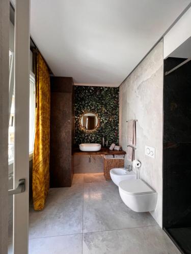 a bathroom with two sinks and a mirror at beach house in Chioggia