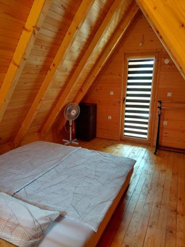 a bedroom with a bed in a attic at A-frame Đukić in Jajce