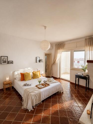 a bedroom with a large white bed and a table at Canneddi Boutique Farm in Avetrana