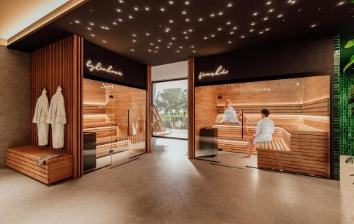 a store with a woman sitting in a bed at Hotel a vinařství Lacina in Velké Pavlovice