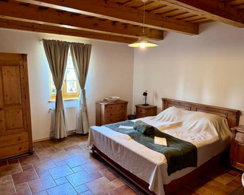 a bedroom with a bed and a window at The Szigliget Residence in Szigliget