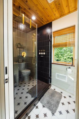 a bathroom with a shower with a glass door at Paddle Point in West Milford