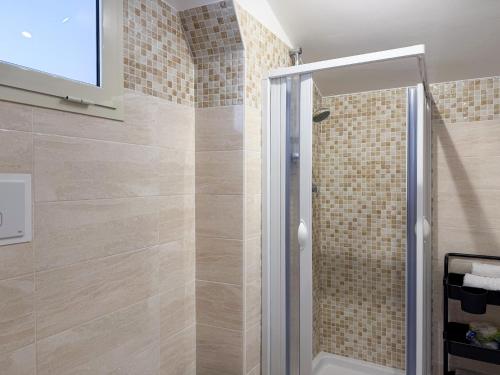 a shower with a glass door in a bathroom at Guest House Maramà in Belvedere Marittimo